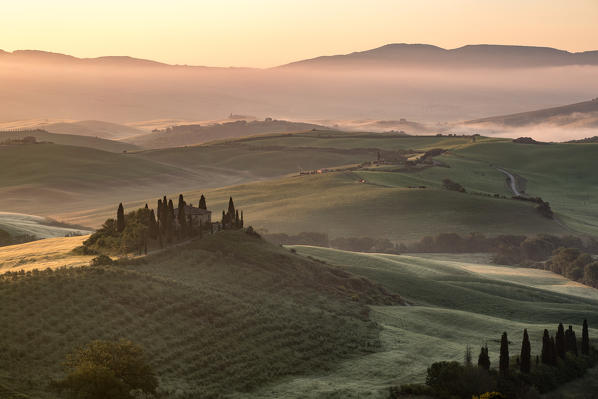 Val d'Orcia, Tuscany, Italy. A lonely farmhouse with cypress and olive trees