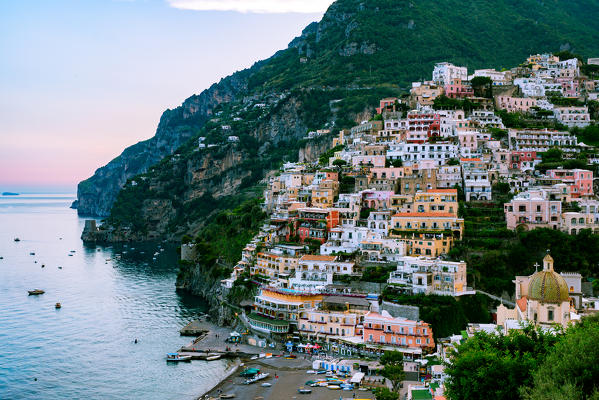 Positano, Amalfi Coast, Campania, Sorrento, Italy. View of the town and the seaside in a summer sunset