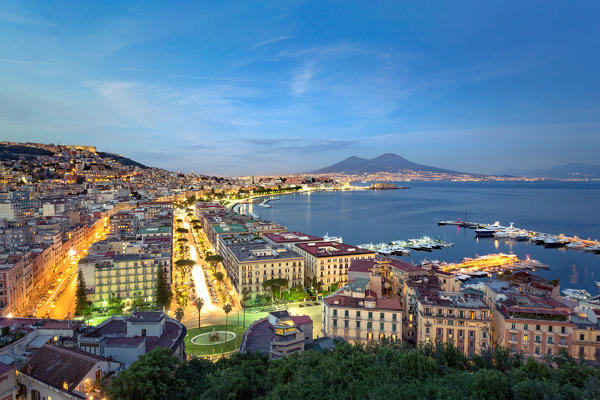 Naples, Campania, Italy. View of the bay by night and Mount Vesuvius Volcano in background