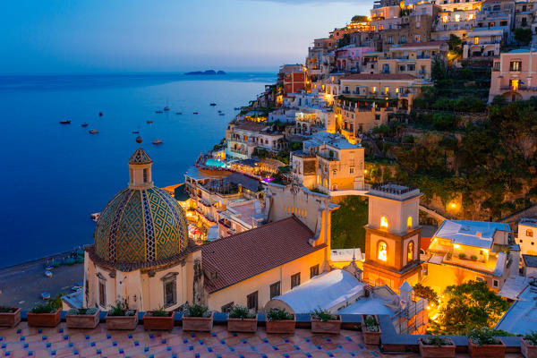 Positano, Amalfi Coast, Campania, Sorrento, Italy. View of the town and seaside in a summer sunset