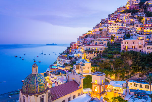 Positano, Amalfi Coast, Campania, Sorrento, Italy. View of the town and the seaside in a summer sunset