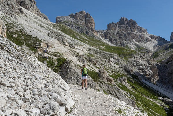 Italy, Trentino Alto Adige, Val di Fassa, Hiker on his way to the Principe Pass along the trial n.584 from the Vajolet refuge