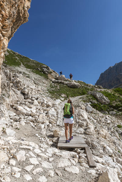 Italy, Trentino Alto Adige, Val di Fassa, Hiker on his way to the Principe Pass along the trial n.584 from the Vajolet refuge