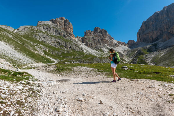 Italy, Trentino Alto Adige, Val di Fassa, Hiker on his way to the Principe Pass along the trial n.584 from the Vajolet refuge