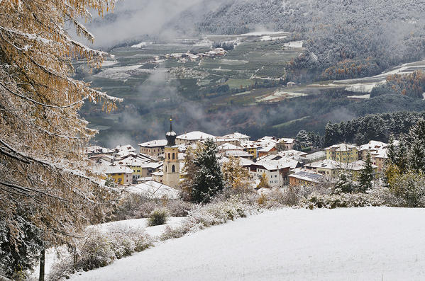 Italy,Trentino Alto Adige, Non valley, autumn snowfall on the Fondo village.