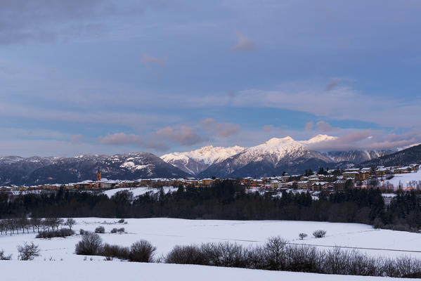 Italy;Trentino Alto Adige;Non valley, panoramic view of Romeno Village and Maddalene group in a winter day in the blue hour.