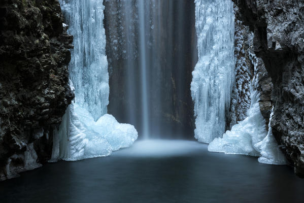 Waterfall from Smeraldo lake in winter, Non Valley, Trentino Alto Adige, Italy.