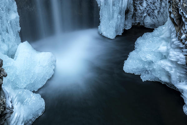 Waterfall from Smeraldo lake in winter, Non Valley, Trentino Alto Adige, Italy.