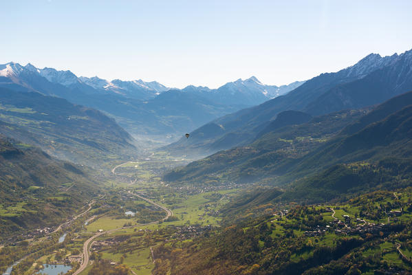 hot air balloon flies over Aosta city, Valle d'Aosta, Italy, Europe.