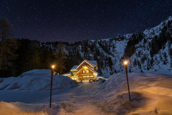 Italy, Trentino Alto Adige, starry night over Nambino refuge in natural park Adamello Brenta.