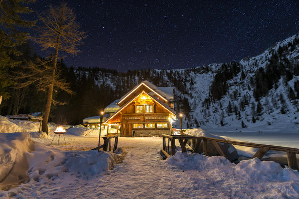 Italy, Trentino Alto Adige, starry night over Nambino refuge in natural park Adamello Brenta.