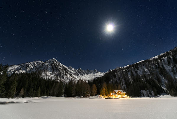 Italy, Trentino Alto Adige, starry night over Nambino refuge in natural park Adamello Brenta.