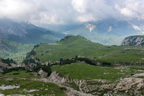 Europe, Italy, Veneto, Belluno. Landscape toward Misurina lake and the mountains around from the path near Auronzo hut at Tre Cime di Lavaredo