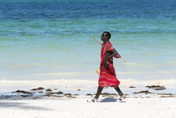 East Africa, Tanzania, Zanzibar, Masai walk on kiwengwa beach.