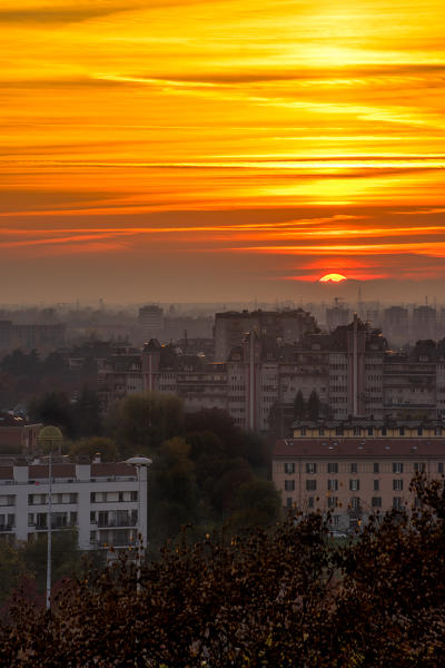 MIlan, Lombardy, Italy. Sunset with fog from Monte Stella, St. Siro district.