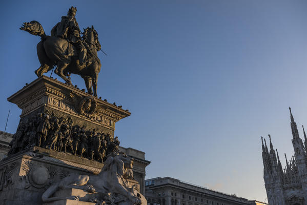 Cathedral Square, Milan, Lombardy, Italy. The statue of King Victor Ammanuel II at dawn.