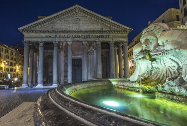 Rome, Lazio, Italy. The Fontana del Pantheon at night, on the background the Pantheon