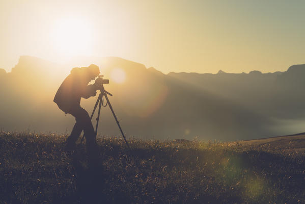 Alpe di Siusi/Seiser Alm, Dolomites, South Tyrol, Italy. A photographer catch the sunrise.