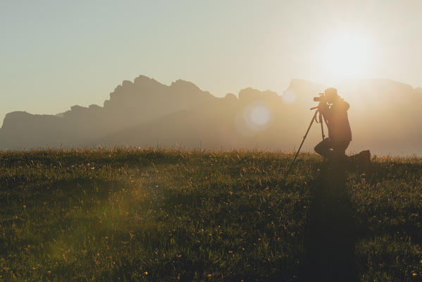 Alpe di Siusi/Seiser Alm, Dolomites, South Tyrol, Italy. A photographer catch the sunrise.