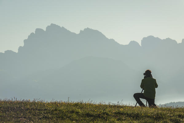 Alpe di Siusi/Seiser Alm, Dolomites, South Tyrol, Italy. A photographer catch the sunrise.