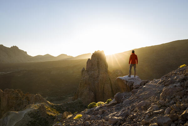 Spain,Canary Islands,Tenerife,Teide National Park, hiker admires sunset in front of roques de Garcia (MR)