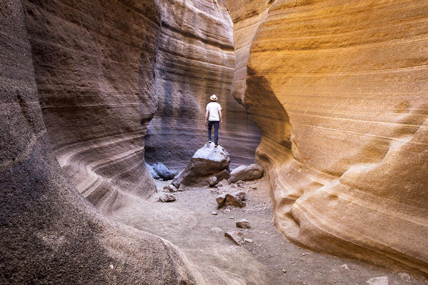 Spain, Canary Islands, Gran Canaria,Las Palmas, a man standing in the canyon of Barranco de Las Vacas (MR)