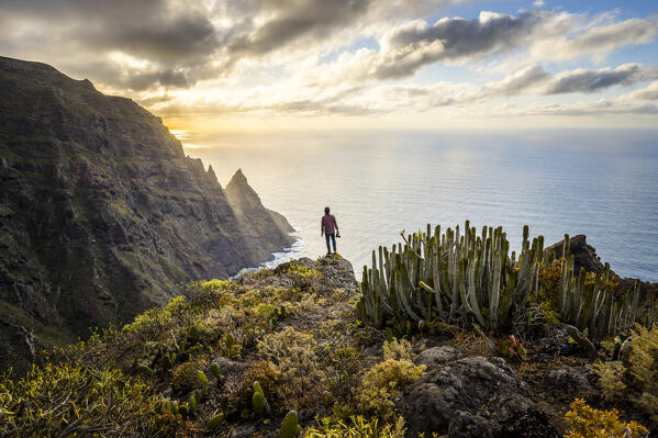 Spain,Canary Islands,Tenerife, hiker admires sunset from cliffs of Anaga Rural Park (MR)