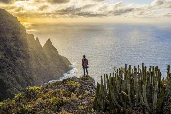 Spain,Canary Islands,Tenerife, hiker admires sunset from cliffs of Anaga Rural Park (MR)