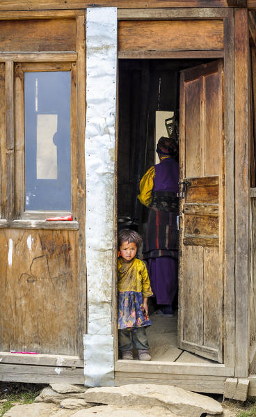 Curious baby on the doorstep,Rasuwa district, Bagmati region,Nepal,Asia