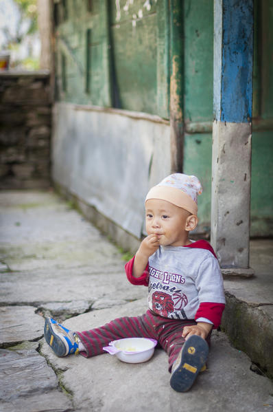 Breakfast time for this cute baby,Annapurna region,Nepal, Asia