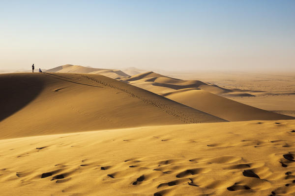 Tourists on top of a sand dune,Walvis Bay,Namibia,Africa