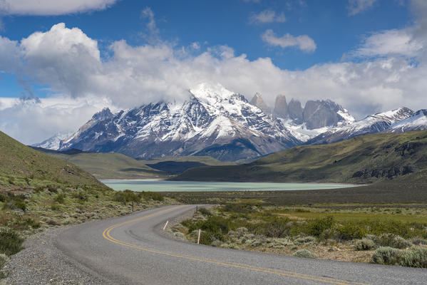 Road to Laguna Amarga, with Paine Towers in the background in summer.  Torres del Paine National Park, Ultima Esperanza province, Magallanes region, Chile.