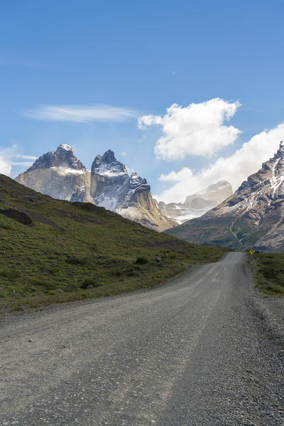 Dirt road with Paine Horns in summer. Torres del Paine National Park, Ultima Esperanza province, Magallanes region, Chile.