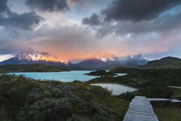 Pehoé Lake with Cerro Paine Grande, Paine Horns and Cerro Paine covered in mist at dawn. Torres del Paine National Park, Ultima Esperanza province, Magallanes region, Chile.