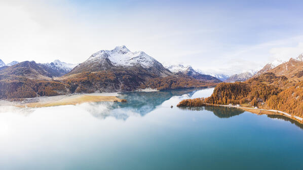 Switzerland, Canton of the Grisons, Maloja region, Sils im Engadin/Segl: snowcapped La Margna peak reflecting on Lake Sils in autumn.