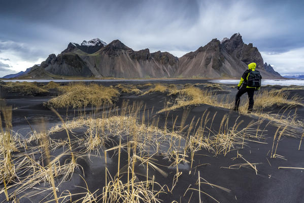 Man overlooking the landscape at Stokksnes, Eastern Iceland, Europe