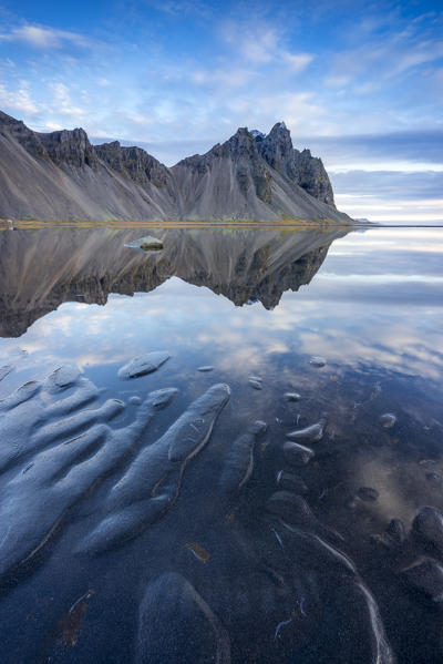 The mountains reflect on the surface of the ocean. Stokksnes, Eastern Iceland, Europe