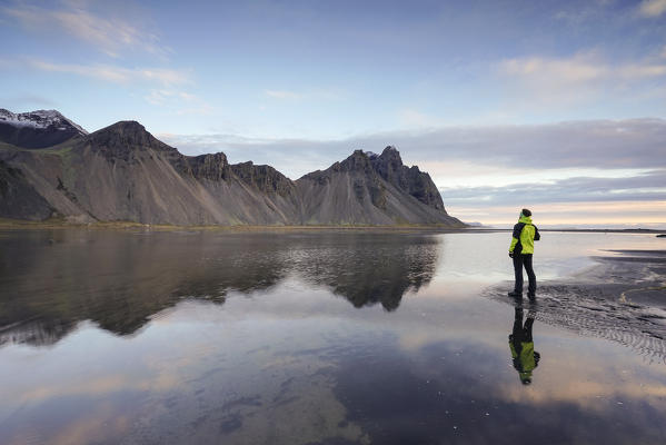 Man overlooking the landscape at Stokksnes, Eastern Iceland, Europe