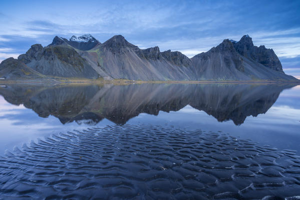 The mountains reflect on the surface of the ocean. Stokksnes, Eastern Iceland, Europe