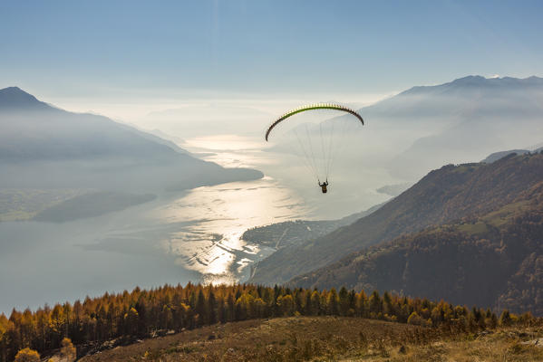 Paragliding over Lake Como and the surroundings mountains. Alto Lario, Como, Lombardy, Italy, Europe.