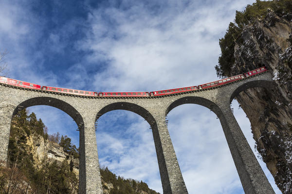 Bernina Express red train  along Landwasser Viaduct. Filisur, Graubunden, Switzerland, Europe.