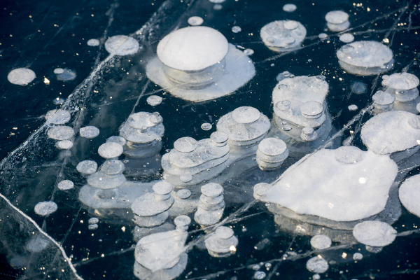 Frozen gas bubbles trapped in the ice. Silvaplana Lake, Silvaplana, Engadin, Graubunden, Switzerland, Europe.