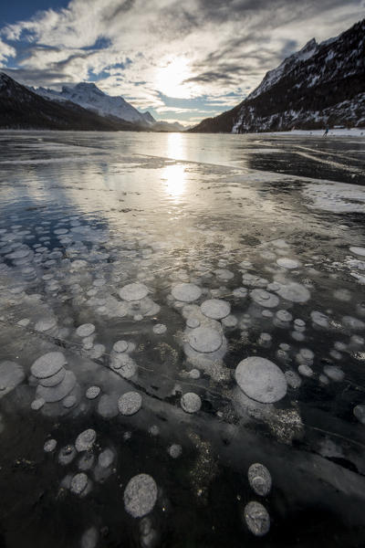 Frozen gas bubbles trapped in the ice. Silvaplana Lake, Silvaplana, Engadin, Graubunden, Switzerland, Europe.