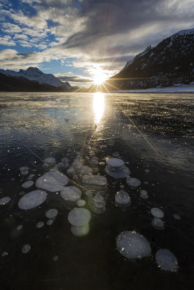 Frozen gas bubbles trapped in the ice. Silvaplana Lake, Silvaplana, Engadin, Graubunden, Switzerland, Europe.
