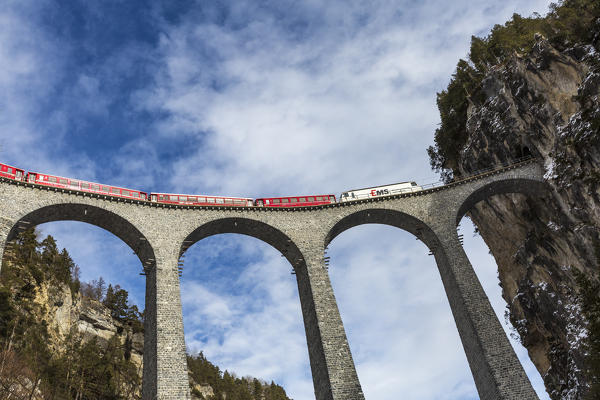 Bernina Express red train  along Landwasser Viaduct. Filisur, Graubunden, Switzerland, Europe.