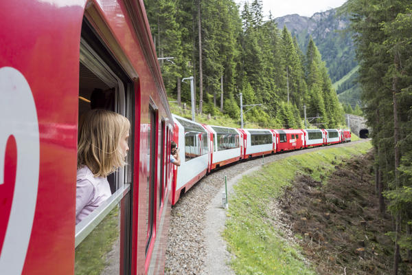 Tourists looking out of the red train wondows, Graubunden, Switzerland