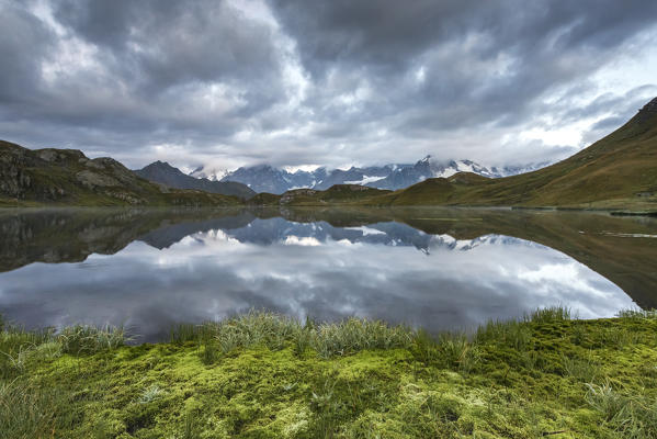 Cloudy sky over Fenetre Lake and the Mont Blanc massif, Ferret valley, Switzerland