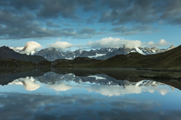 Cloudy sky over Fenetre Lake and the Mont Blanc massif, Ferret valley, Switzerland