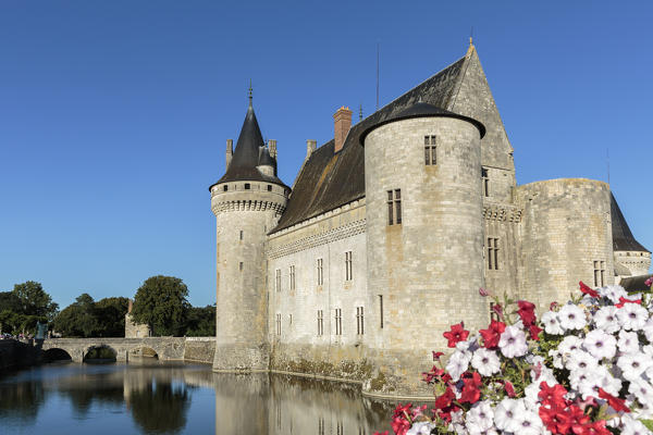 Medieval castle with flowers on the foreground. Sully-sur-Loire, Loiret, France.