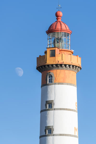 Moon and detail of Saint-Mathieu lighthouse. Plougonvelin, Finistère, Brittany, France.